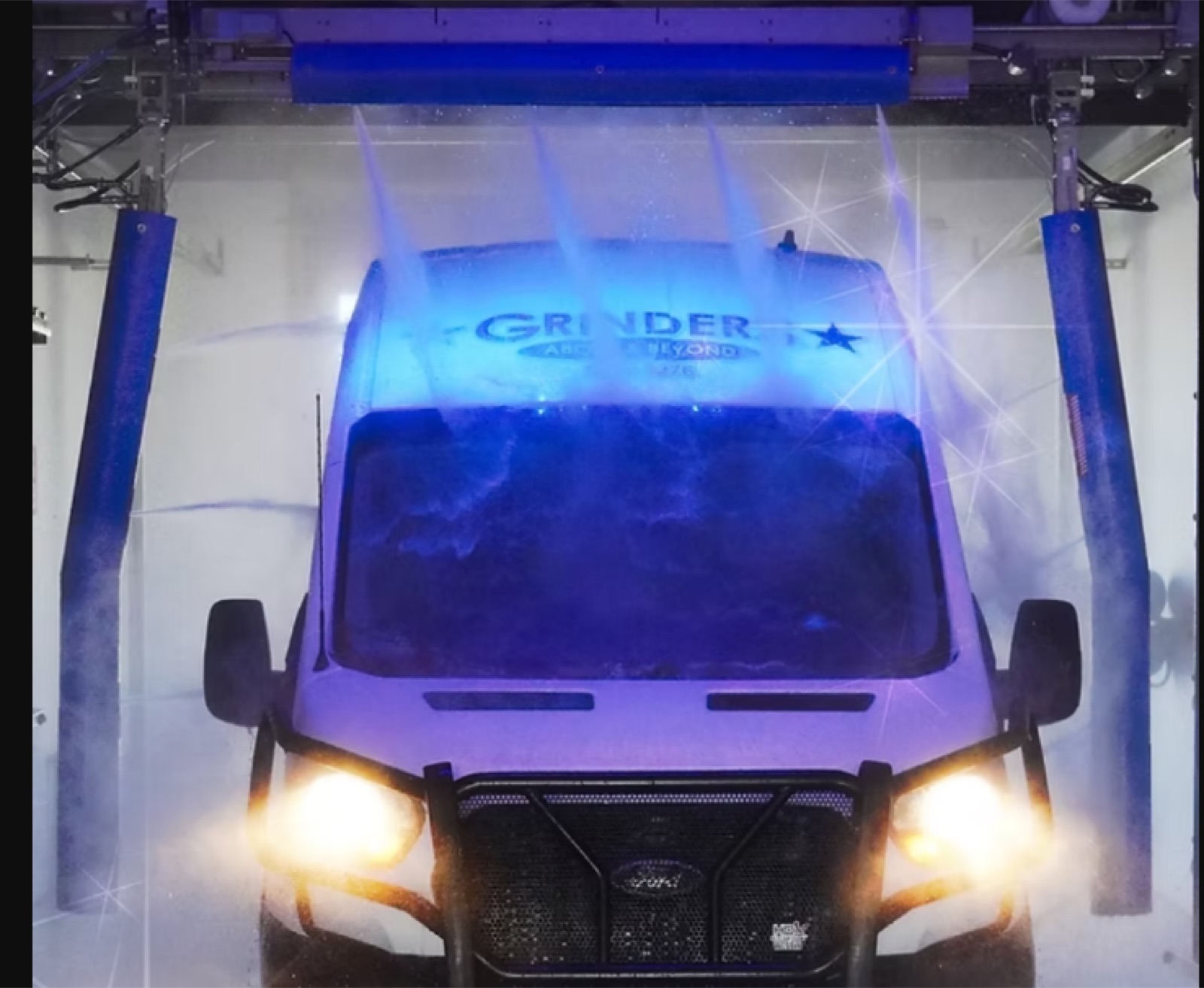Van positioned in an Al's Super Wash touchless bay as sensors profile the vehicle